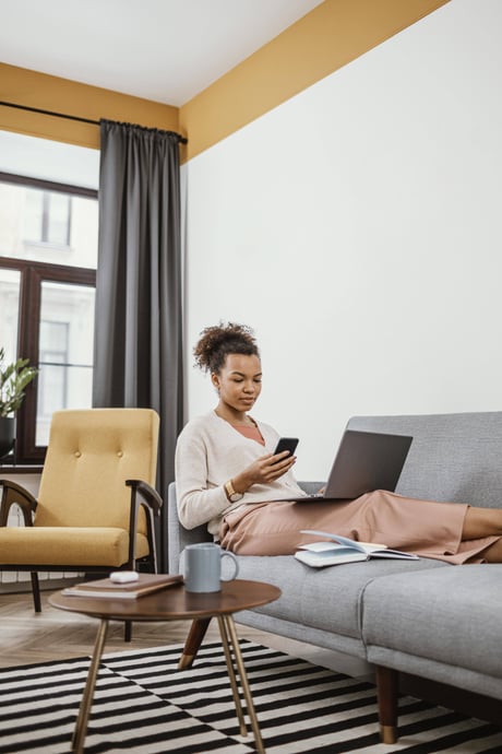 young-woman-working-while-sitting-sofa